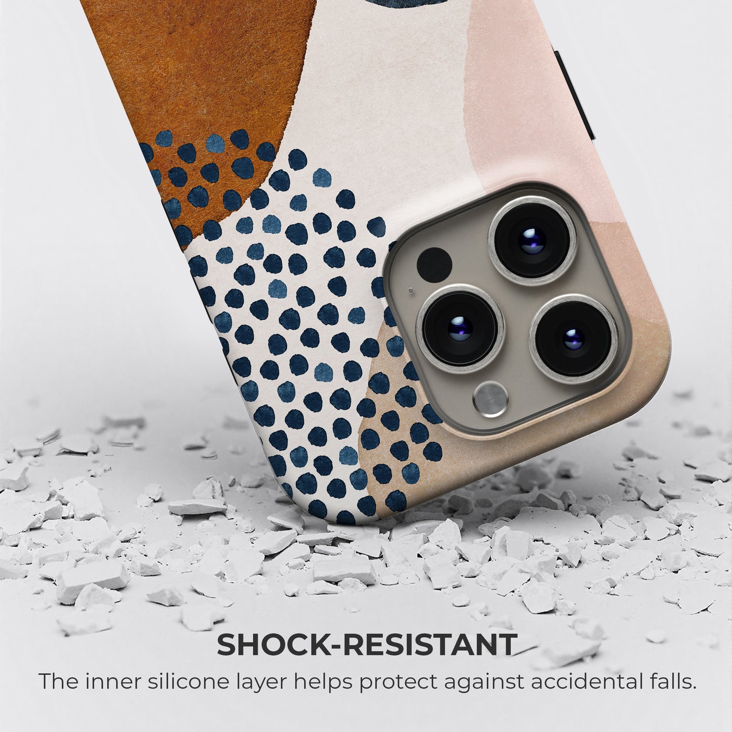 Abstract terracotta and navy blue tough phone case showing shock-resistant protection with inner silicone layer guarding against accidental drops