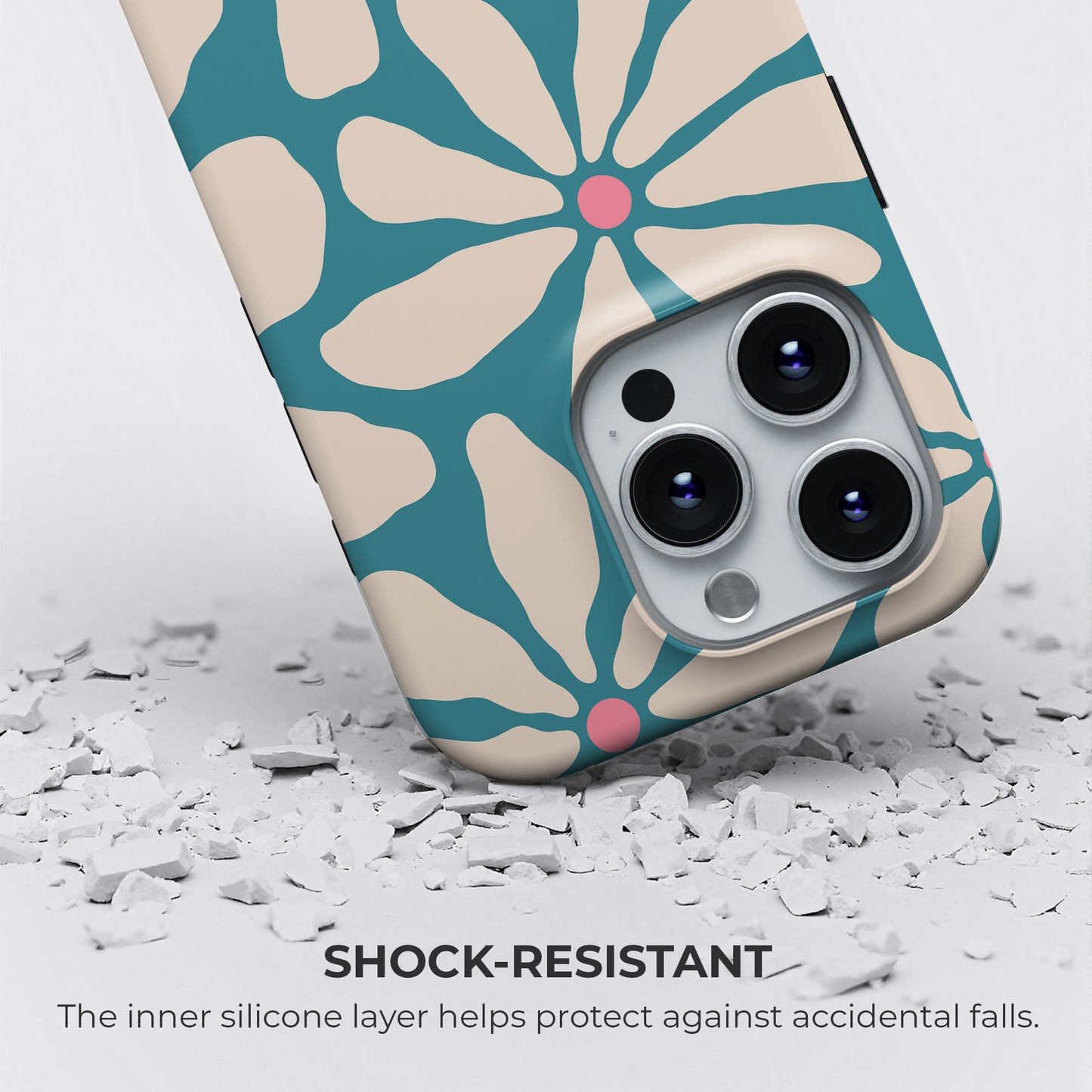 HaloCovers retro floral phone case with teal blue flower petals and pink centers, shock-resistant silicone layer protects against drops and accidental falls