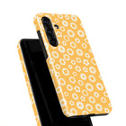 a phone case with a yellow floral pattern.
