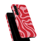a smartphone case with a vibrant red and pink wavy pattern.