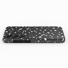 A black and white speckled pattern on the back of a smartphone case.