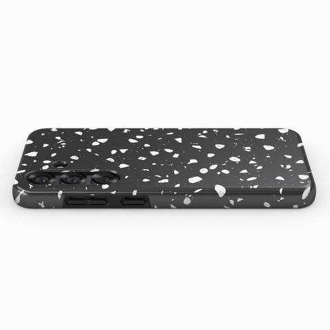 A black and white speckled pattern on the back of a smartphone case.