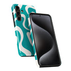 a teal and white patterned case for a smartphone, with the back and front views showing the design.