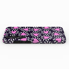 a phone case with a pattern of pink hearts on a dark background.