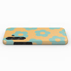 A phone case with a floral pattern in shades of yellow and blue.