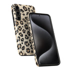 a smartphone with a leopard print case on it.