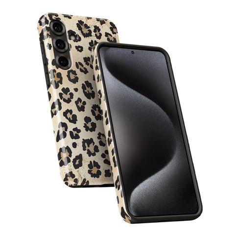 a smartphone with a leopard print case on it.