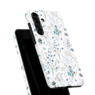 a white phone case with a floral pattern on it.