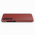 A red phone case with white polka dots.