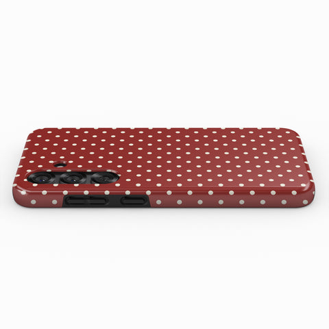 A red phone case with white polka dots.