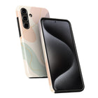 a smartphone case with a unique abstract design, including a combination of pink, green, and black colors. The case appears to be made of a soft, flexible material, suitable for protecting the phone.