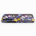 a colorful, patterned phone case with a variety of flowers and leaves in different colors, including blue, pink, yellow, and orange.