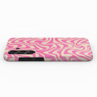 a pink and white swirled pattern on a phone case.