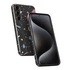 a smartphone with a black case and a colorful, speckled pattern on the back.