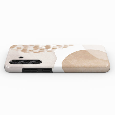 a phone case with a minimalist design featuring a beige and brown color scheme, along with a pattern of small circles or dots.