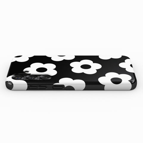 A black and white phone case with a repeating pattern of white flowers on a black background.