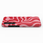 A red and pink swirly pattern on a phone case.