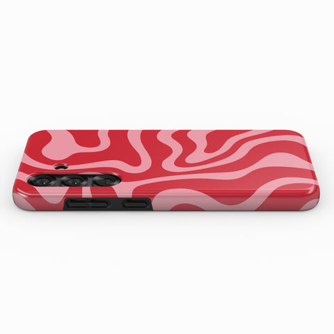 A red and pink swirly pattern on a phone case.