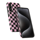 a smartphone with a pink and black checkered pattern on its back cover and a black screen.