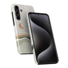 a smartphone case with a pattern of dots and a crescent moon design. The case is black and has a curved shape, which is designed to fit the phone.