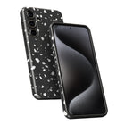 a black smartphone with a speckled pattern on its back cover.