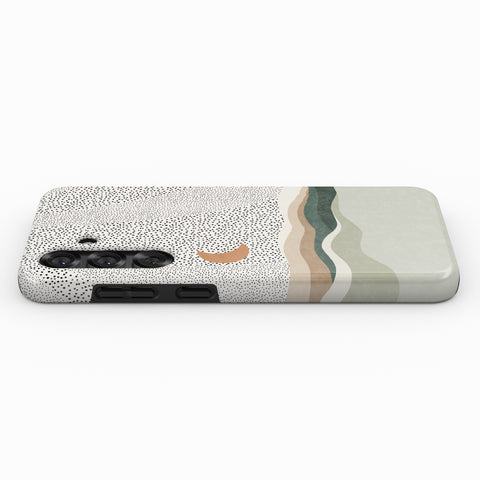 a phone case with a dotted pattern and a moon-like design on it.