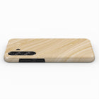 A wooden phone case with a marble-like texture and gold accents.