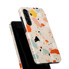 a colorful phone case with a speckled pattern, including shades of orange, pink, and green.