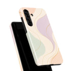 a phone case with a colorful abstract design, including lines and swirls in various shades of pink, green, and beige.
