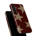 A maroon-colored phone case with a leopard print star pattern.