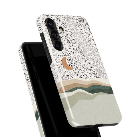 a phone case with a dotted pattern and a crescent moon design.