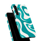 a teal and white swirly pattern on a phone case.