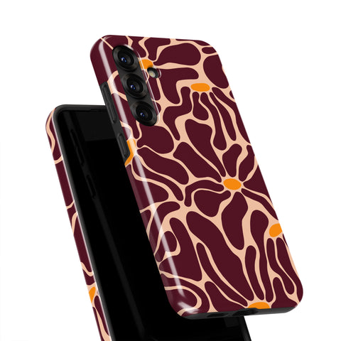 a smartphone case with a floral pattern in shades of burgundy and orange.