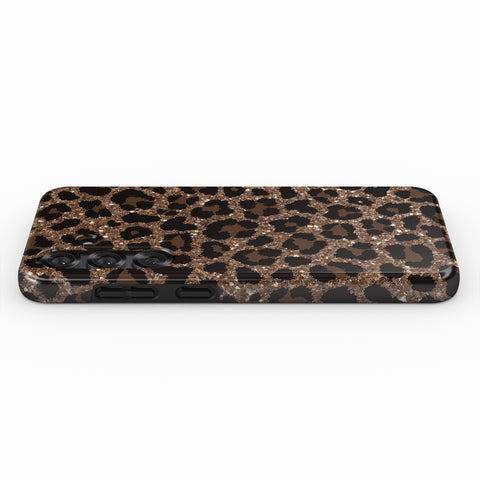 A phone case with a leopard print design, featuring brown and black spots with a glittery texture.