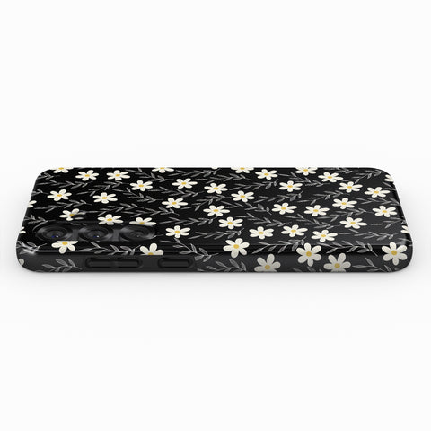 A black phone case with a white floral pattern on it.