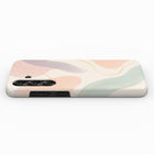 a phone case with a colorful abstract design featuring curved lines in various shades of pink, green, and beige.
