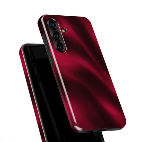 A close-up view of a red smartphone case with a shiny, reflective surface.