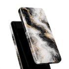 a marble-patterned phone case with a black and white color scheme.