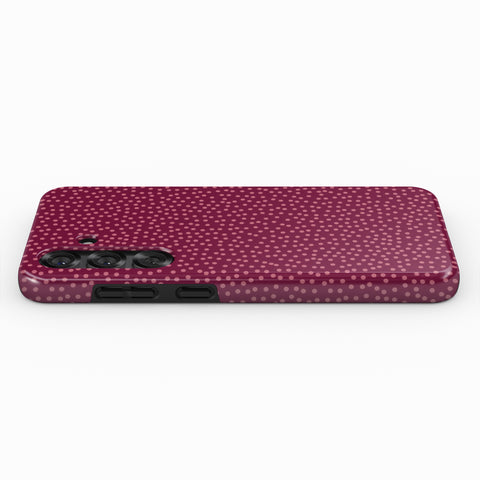 A pink dotted pattern case for a smartphone.