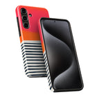 a smartphone with a colorful case design, including stripes and a black background.