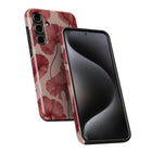 a smartphone case with a floral pattern on the back and a black case on the front.