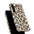 a leopard print phone case with a pattern of black and brown spots.