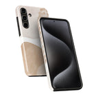 a smartphone case with a beige and black color scheme, with the beige part of the case facing upwards and the black part facing downwards.