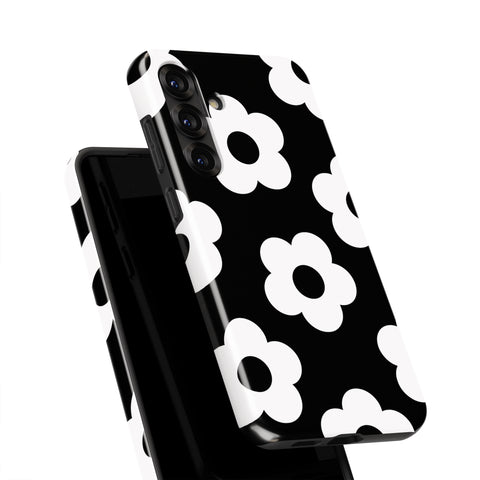 a black and white phone case with a repeating pattern of white flowers on a black background.