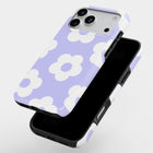 A purple and white phone case with a flower pattern, featuring a camera and flash on the back.
