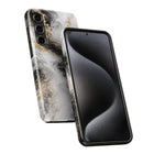 a smartphone with a marble-patterned case on it.