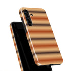 a smartphone case with a striped pattern in shades of orange and brown.