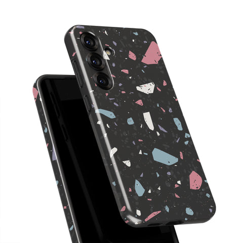 a black phone case with a colorful, abstract pattern of small, irregularly shaped tiles in various shades of pink, blue, and gray.