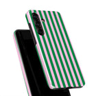 a phone case with a striped pattern in pink and green colors.