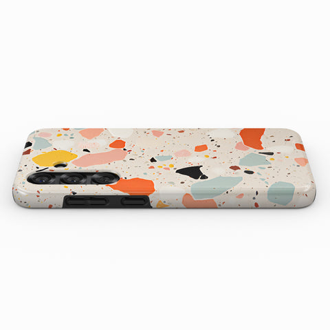 a phone case with a colorful, abstract pattern of various shapes and colors, including shades of orange, pink, blue, and green.
